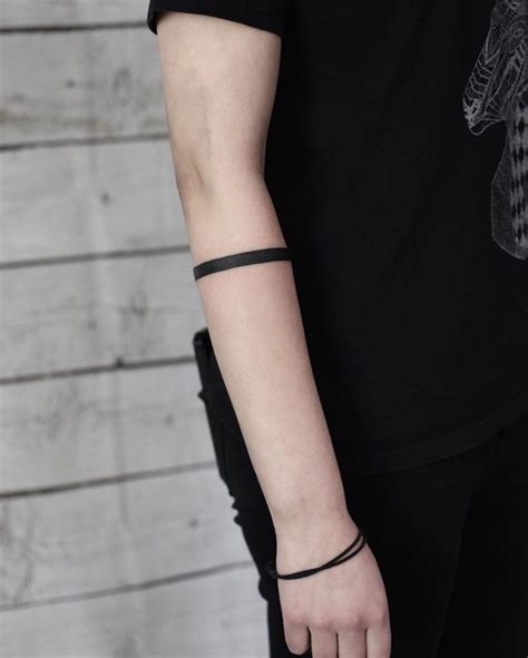 black forearm band tattoo|solid black arm tattoo meanings.